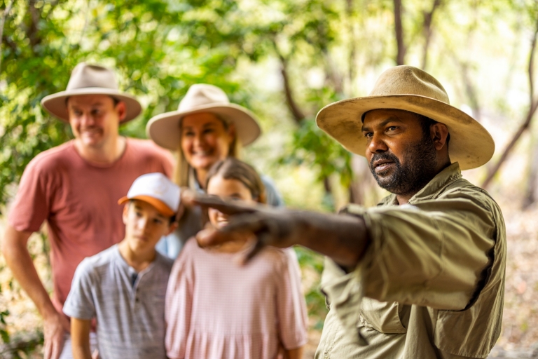 Culture Connect guide pointing as family listen in background, Tropical North Queensland © Tourism Australia