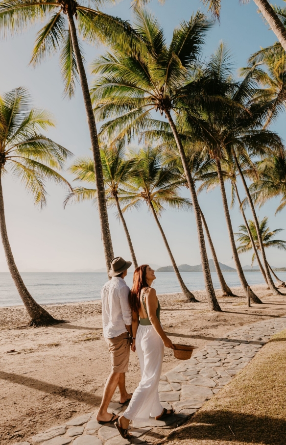 Couple walking under the coconut palms, Palm Beach, Queensland © Tourism and Events Queensland