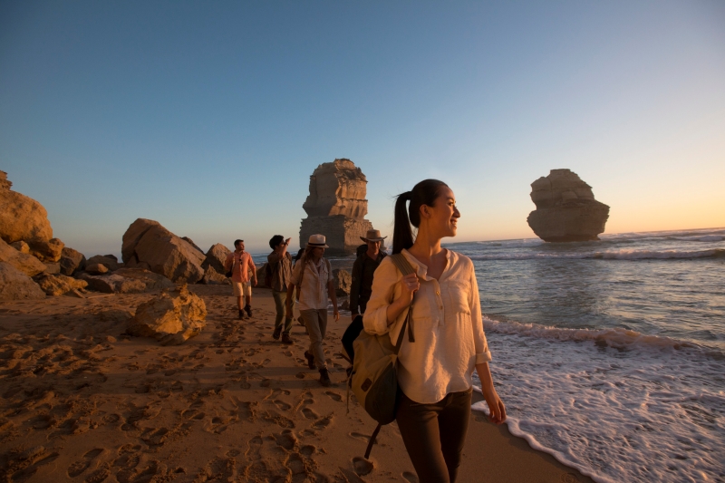 A group walks on the beach admiring the Twelve Apostles, Victoria © Tourism Australia