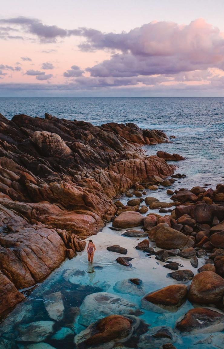 Woman standing in a rockpool in Leeuwin-Naturaliste National Park, Yallingup, Western Australia© Tourism Australia