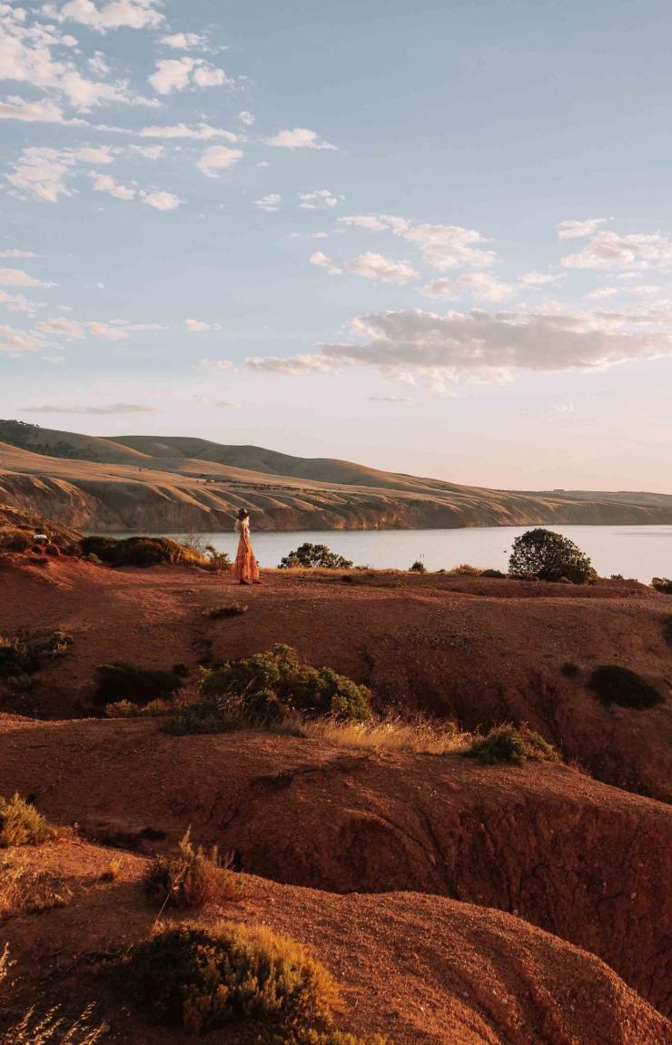 A woman stands on the cliffs of Sellicks Beach in Onkaparinga, South Australia © Tourism Australia