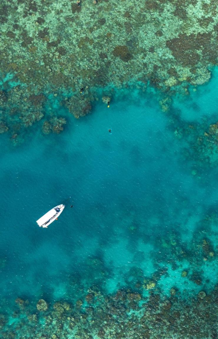 Aerial view of a boat in the blue waters of the Whitsundays, Queensland © Tourism Australia