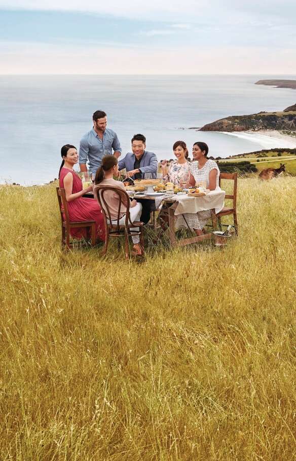 Group dining with a view overlooking the ocean, Kangaroo Island, South Australia © Tourism Australia