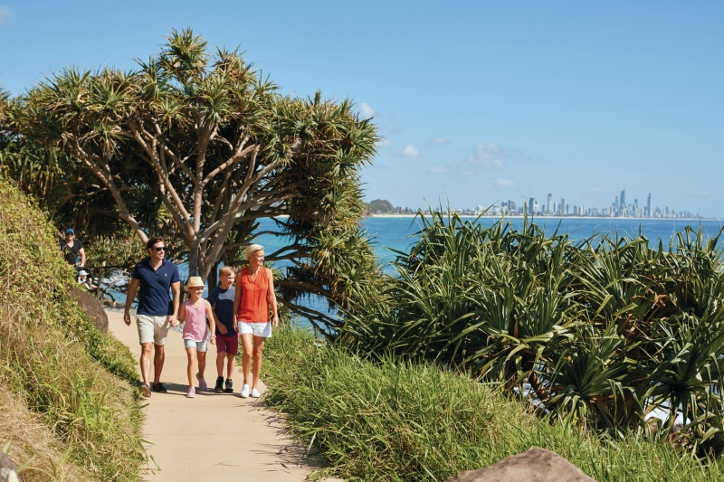 Family walking on a path by the ocean at Burleigh Heads, Gold Coast, Queensland © Tourism and Events Queensland