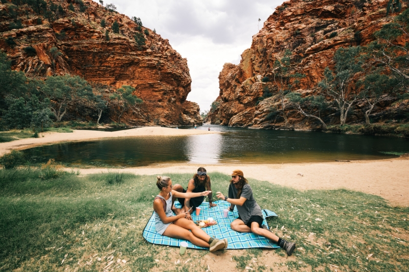 Friends having a picnic at Ellery Creek, West MacDonnell National Park, Northern Territory © Visit Victoria