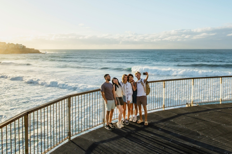 Group of tourists taking a selfie at a lookout at Bondi Beach, Sydney, New South Wales © Destination NSW