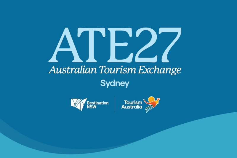 The official digital tile for ATE27, the Australian Tourism Exchange, held in Sydney. The light blue text and logos for Destination NSW and Tourism Australia are set against a vibrant blue background with curved wave patterns.