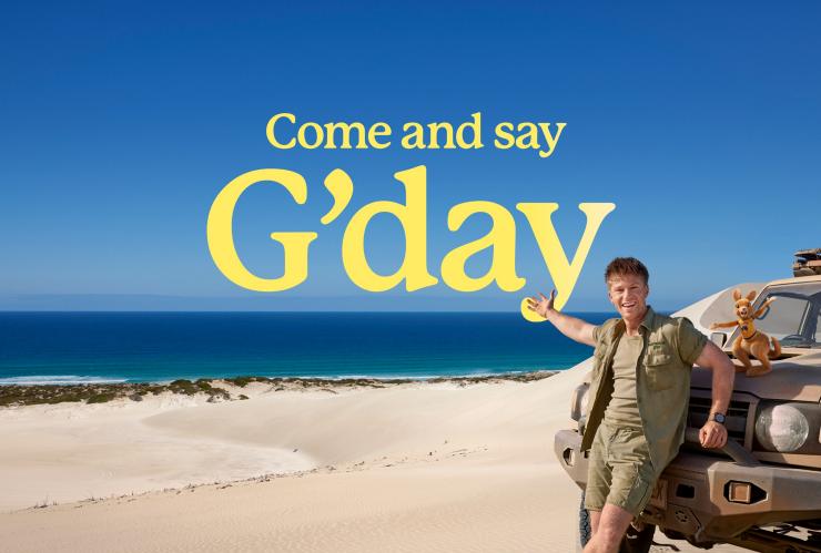 Come and say G'day, Robert Irwin leaning against a 4WD on the beach in Port Lincoln, South Australia © Tourism Australia