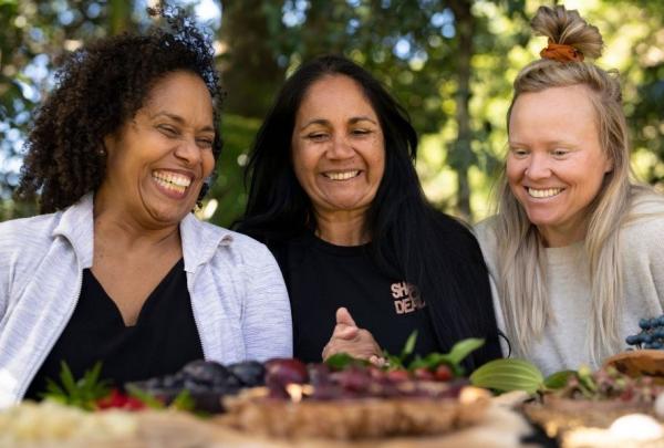 Three people on an Explore Byron Bay tour admire a platter of bush tucker.
