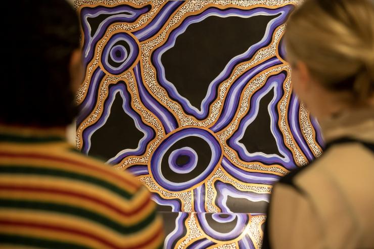 Gallery visitors observing an Indigenous artwork at the Koorie Heritage Trust. © Tourism Australia