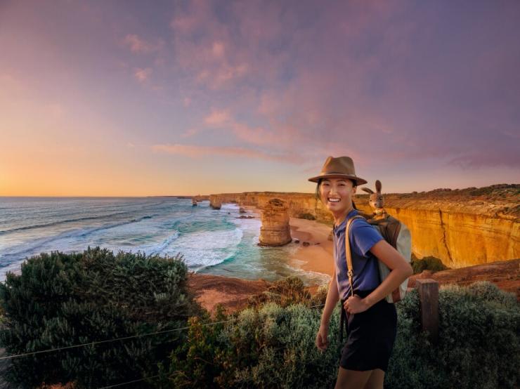 A woman hikes the coastal cliffs above the Twelve Apostles, Victoria A woman hikes the coastal cliffs above the Twelve Apostles, Victoria