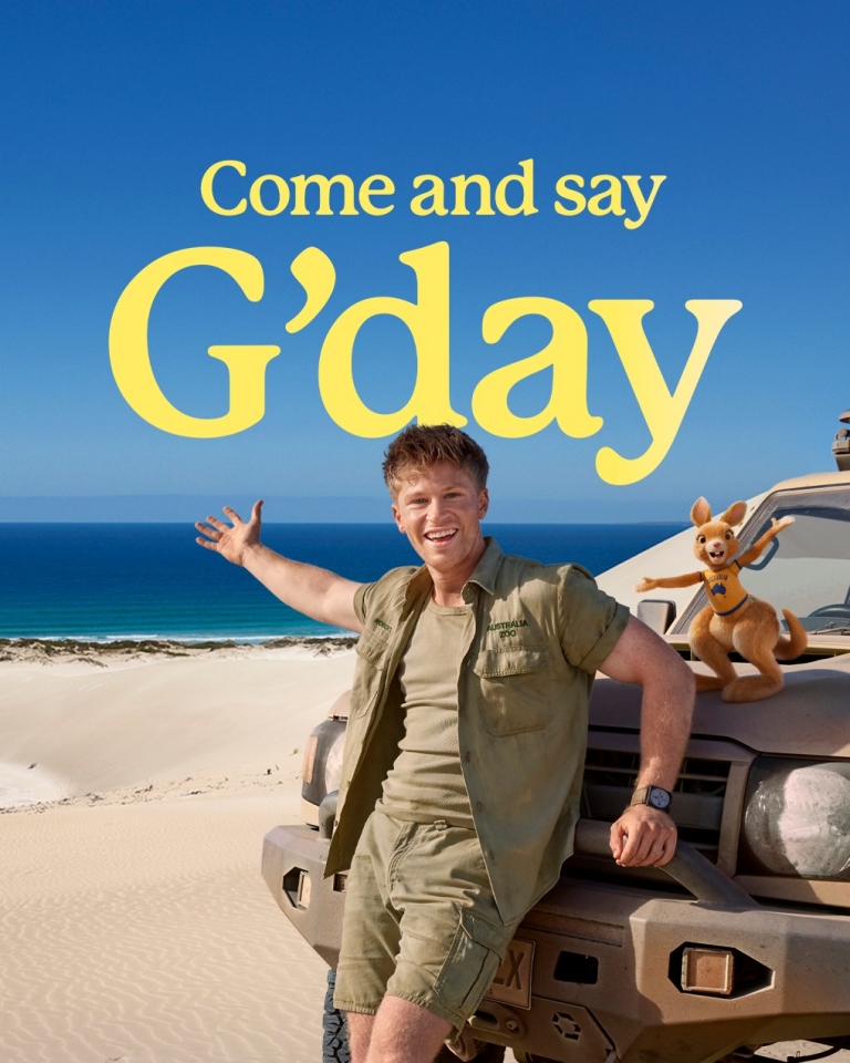 Come and say G'day, Robert Irwin and Ruby the souvenir kangaroo leaning against a 4WD on the beach in Port Lincoln, South Australia © Tourism Australia