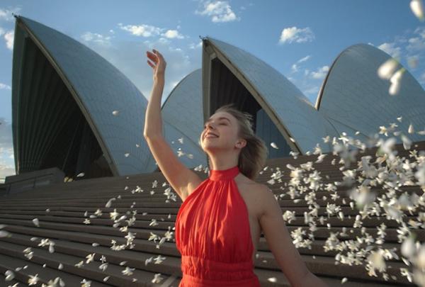 Woman in a red dress dancing on the steps of the Sydney Opera House, Experience Australia in 8D Sound © Tourism Australia