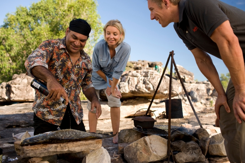 Mark Olive cooking a meal of fish for two guests, Davidson's Arnhemland Safaris, Northern Territory © Tourism Australia