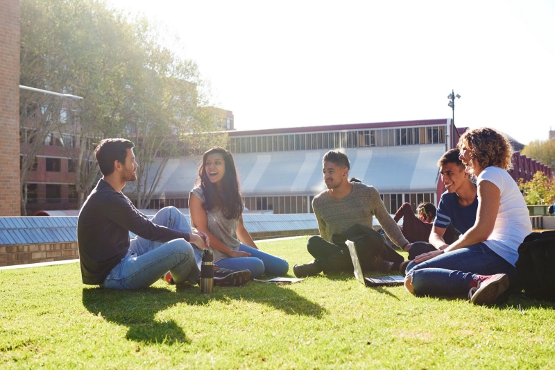 Group of students sitting on the grass at the Goods Line, Ultimo, New South Wales © Destination NSW