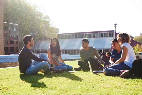 Group of students sitting on the grass at the Goods Line, Ultimo, New South Wales © Destination NSW