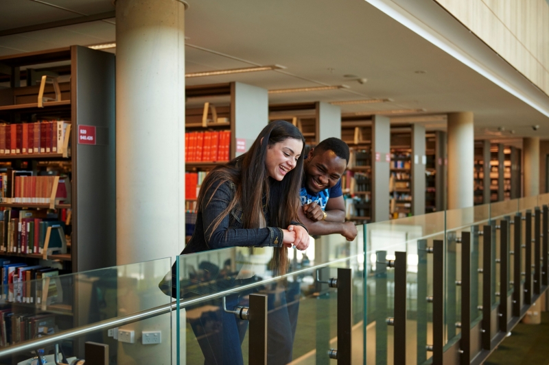 Two students look over the library balustrade at Western Sydney University, Penrith, New South Wales © Destination NSW